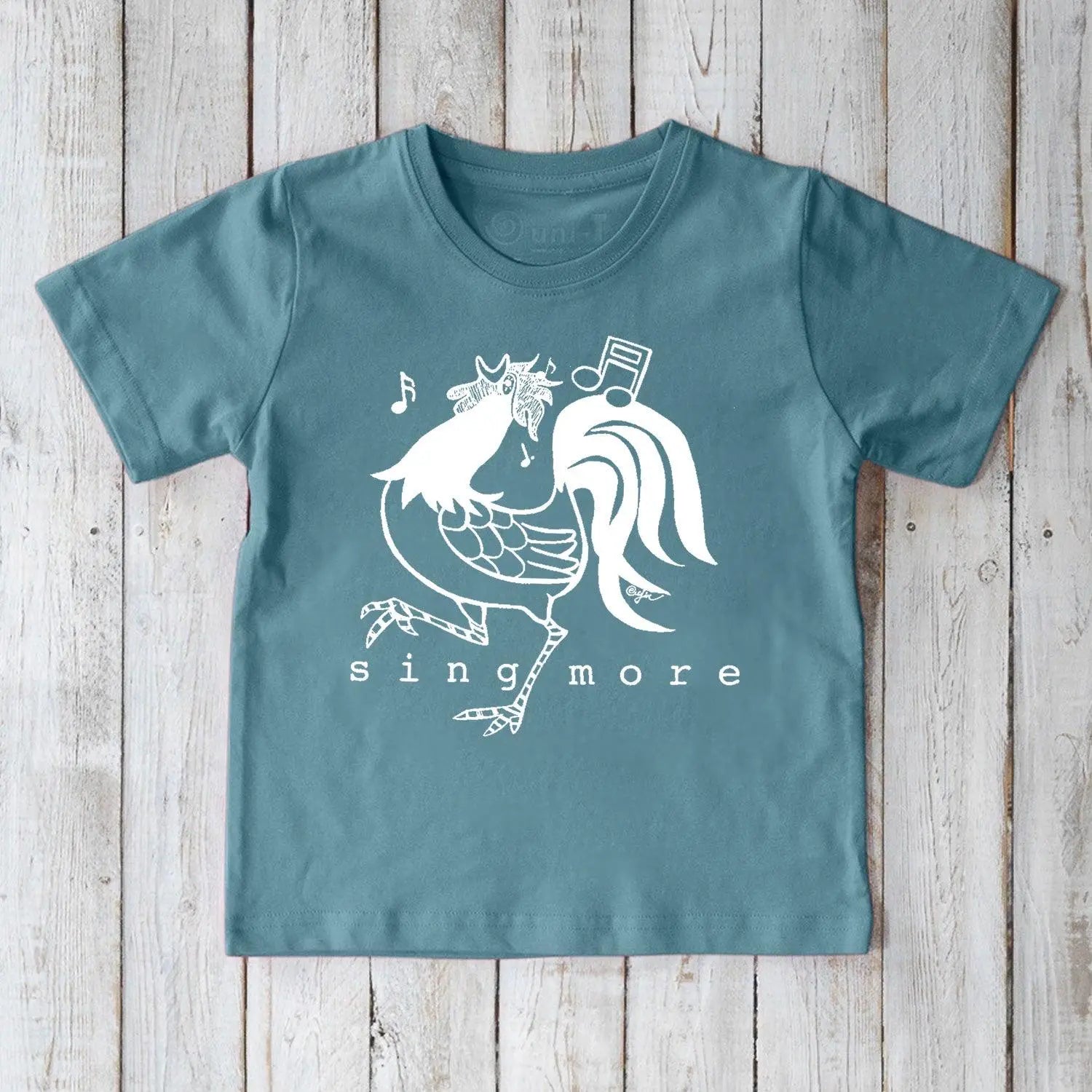Blue kids' rooster t-shirt made from organic cotton, featuring a cheerful 'Sing More' print, ideal for eco-conscious families.