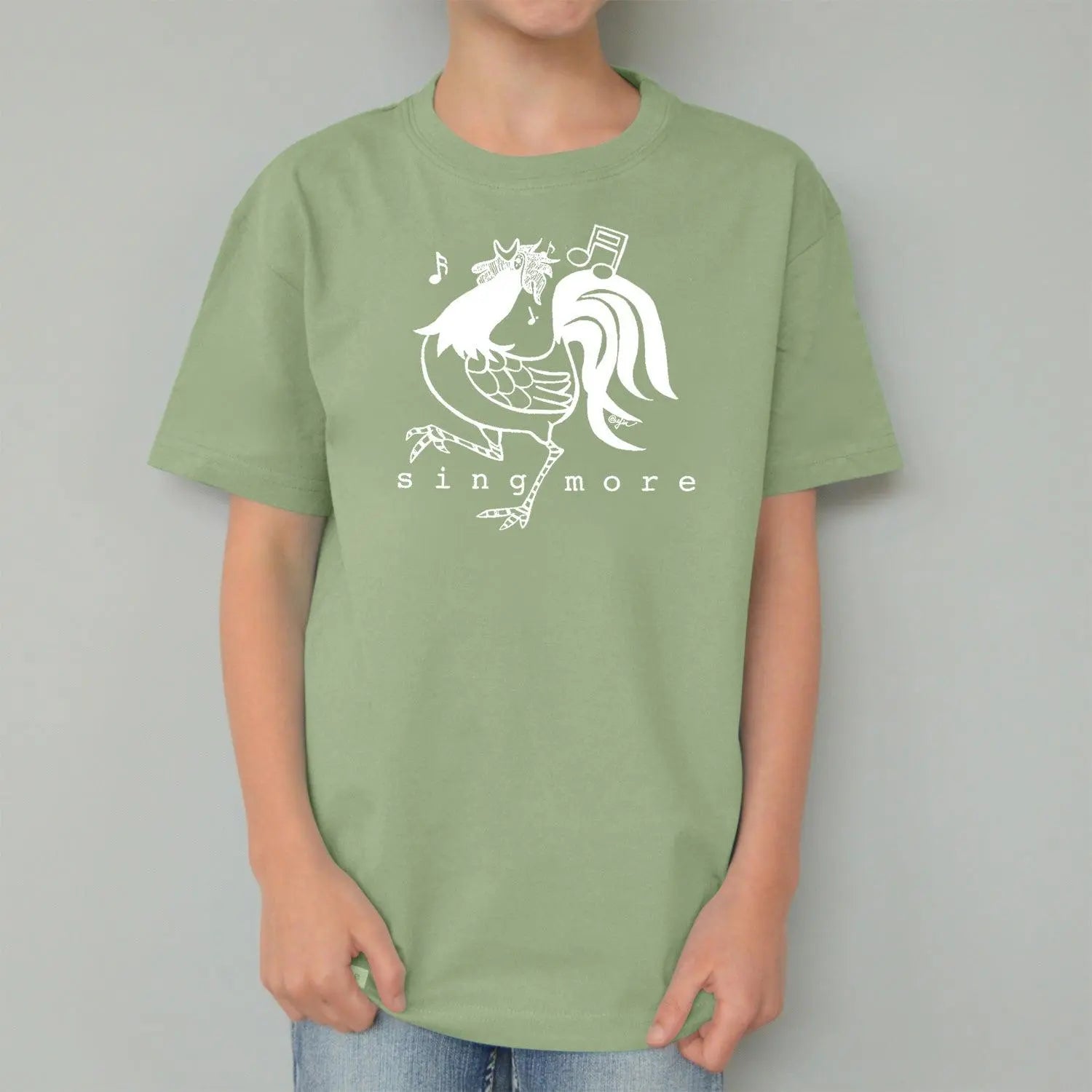 Green rooster graphic t-shirt for kids with 'Sing More' text, made from soft organic cotton for eco-conscious families.