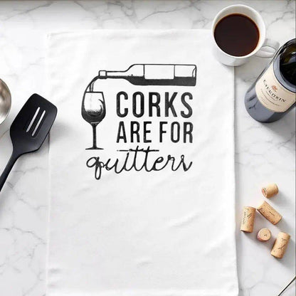 Corks are for Quitters Towel - Fun Kitchen Accessory displayed on marble counter with wine, corks, and utensils. Ideal humorous gift for wine lovers.