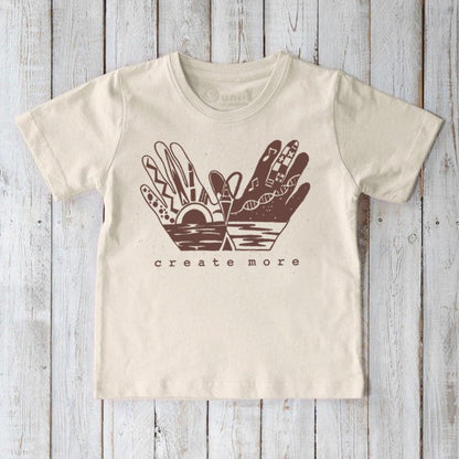 Beige Kids' Organic Cotton Graphic T-Shirt featuring 'Create More' hand design, sustainable and artistic top for young creators by Uni-T.