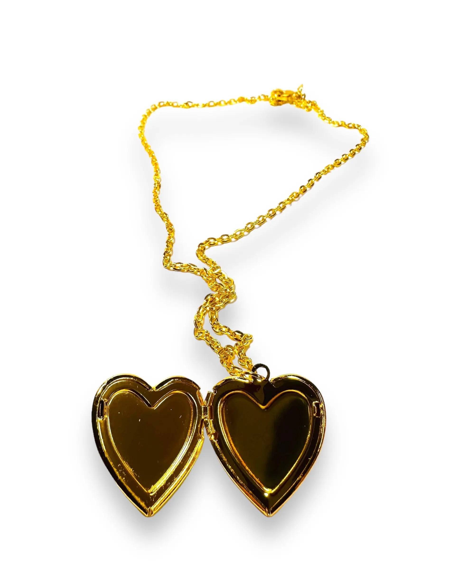 Open heart-shaped brass locket with polished gold-tone interior, perfect for personalizing with photos or tiny mementos.