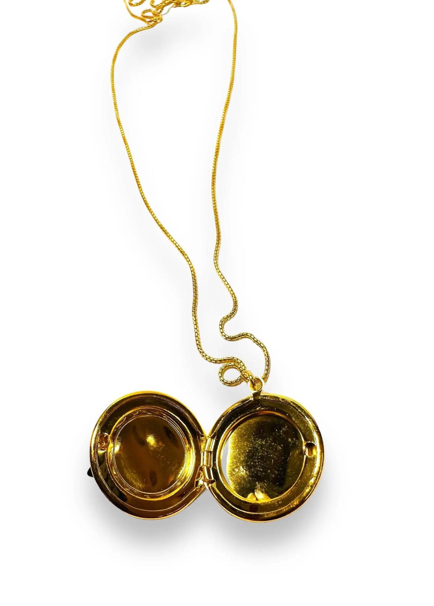 Round brass locket opened to reveal a smooth gold interior, suitable for storing cherished photos or keepsakes.