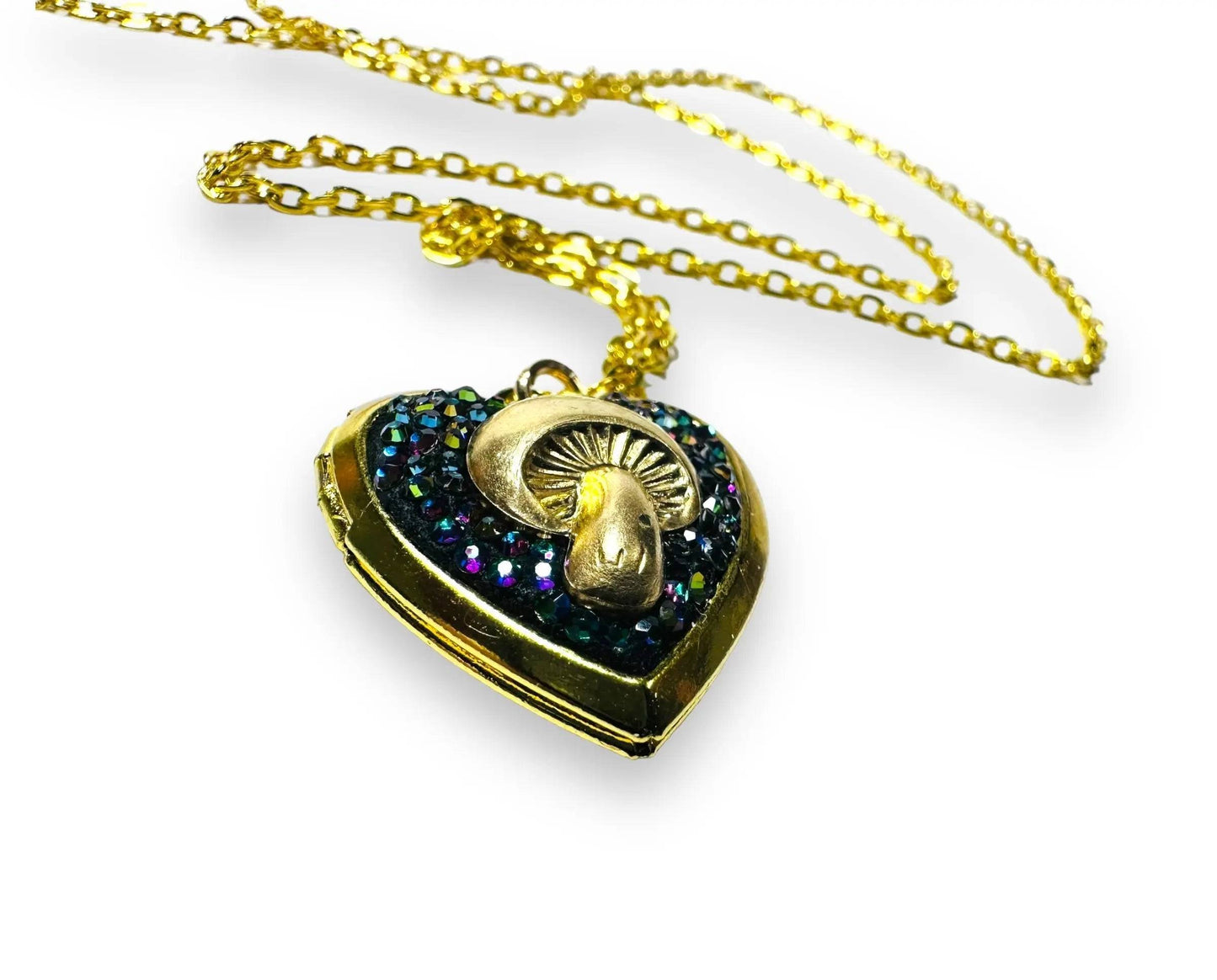 Close-up of heart-shaped brass locket with rainbow crystals and mushroom design, perfect for whimsical jewelry collections.