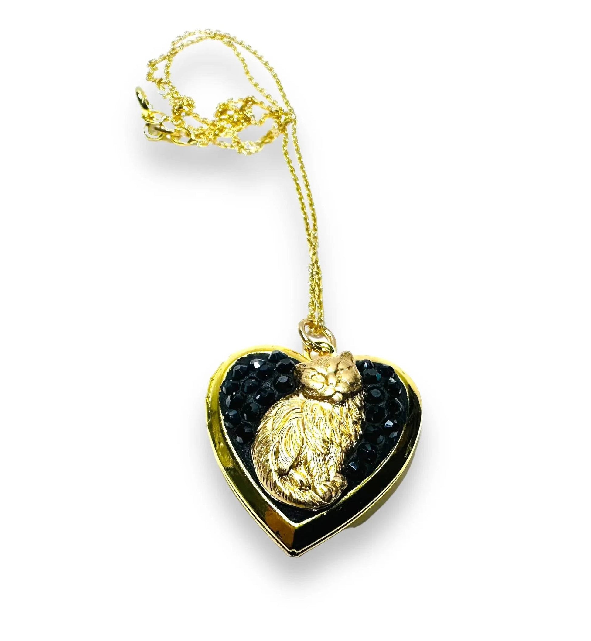 Heart-shaped brass locket with black crystal clay and gold cat figure, a perfect gift for cat jewelry enthusiasts.