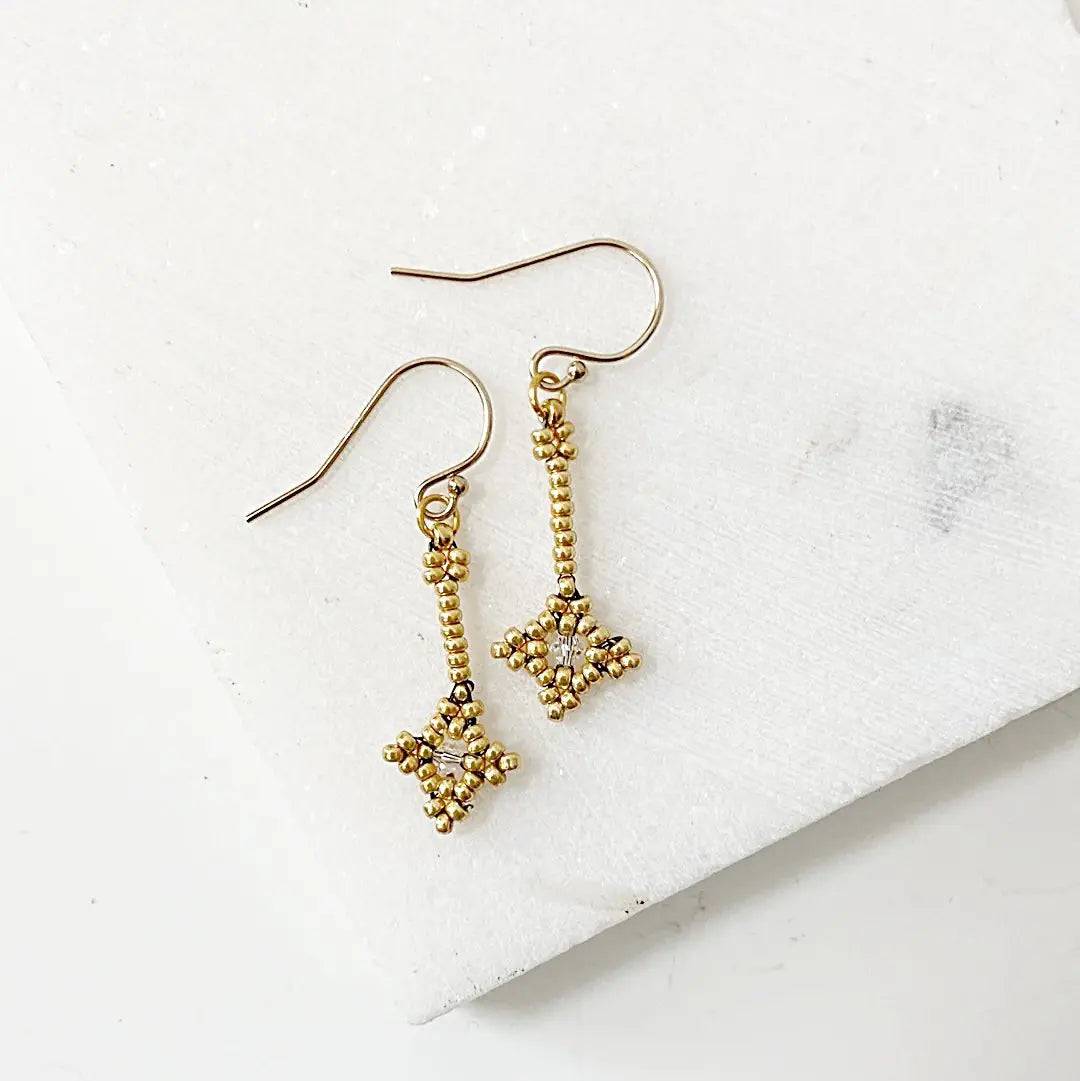 Crystal Woven Earrings in gold with delicate seed bead design and sterling silver ear wires. Elegant accessory for formal or casual wear.