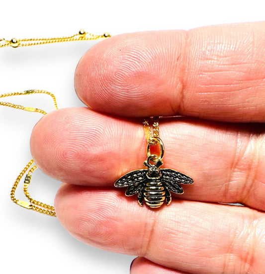 Close-up of Golden Bee Necklace by Uni-T with intricate bee pendant on an 18-inch gold-filled chain, ideal for nature-inspired jewelry lovers.