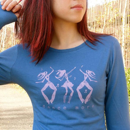Model wearing blue Women's Dance More Long Sleeve T-Shirt with pink dancer print, made from bamboo and organic cotton for active lifestyles.