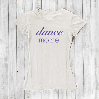 Cream Women's Dance T-Shirt made of bamboo & organic cotton with purple 'dance more' graphic. Sustainable and uplifting tee for dancers.