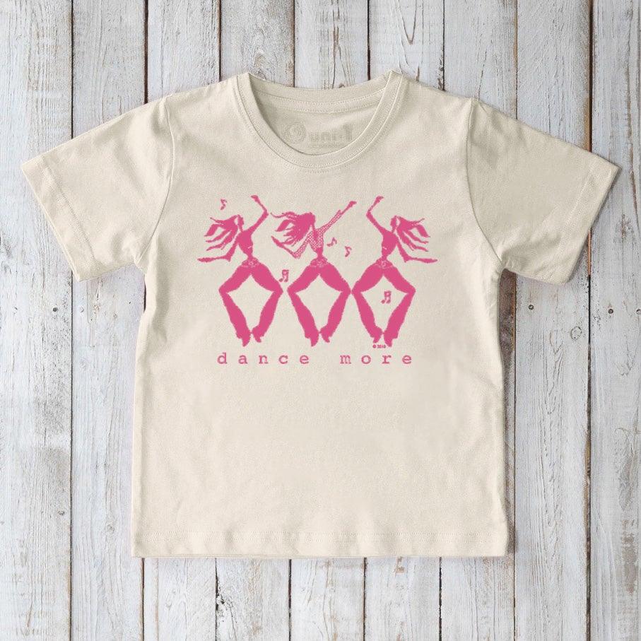 Eco-friendly kids' cream t-shirt with pink 'dance more' graphic, organic cotton tee promoting playful movement and sustainable fashion.