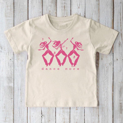 Eco-friendly kids' cream t-shirt with pink 'dance more' graphic, organic cotton tee promoting playful movement and sustainable fashion.