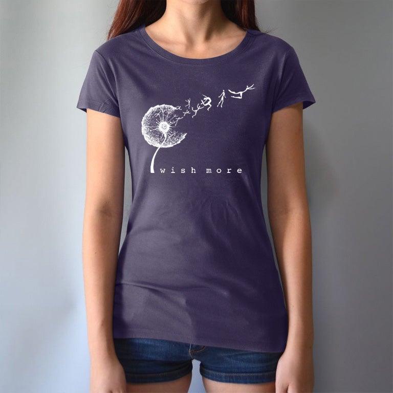 Model wearing navy Women's Dandelion T-Shirt in bamboo & organic cotton with 'Wish More' graphic. Motivational and sustainable fashion by Uni-T.