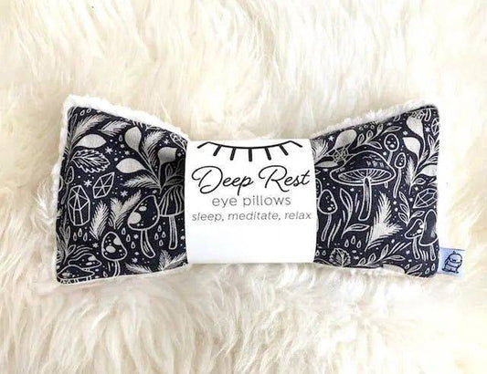 Deep Rest Eye Pillow - Forest Forage placed on soft white fur, showcasing its cozy texture and calming design for sleep and headache relief.