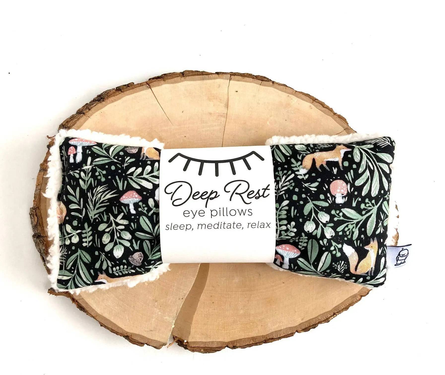 Fox & Toadstool Deep Rest Eye Pillow on wooden slab, featuring calming woodland design for stress relief and relaxation therapy.