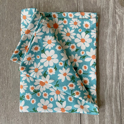 Daisy floral dish towel with matching fabric and ceramic pitcher