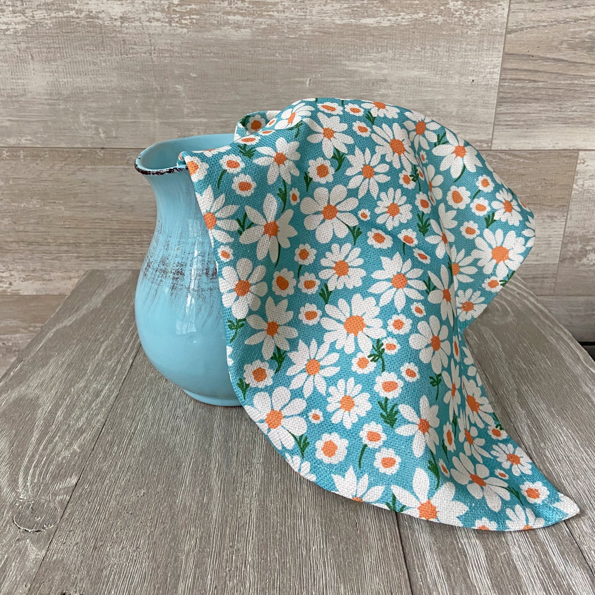 Close-up of daisy print linen cotton tea towel with textured fabric