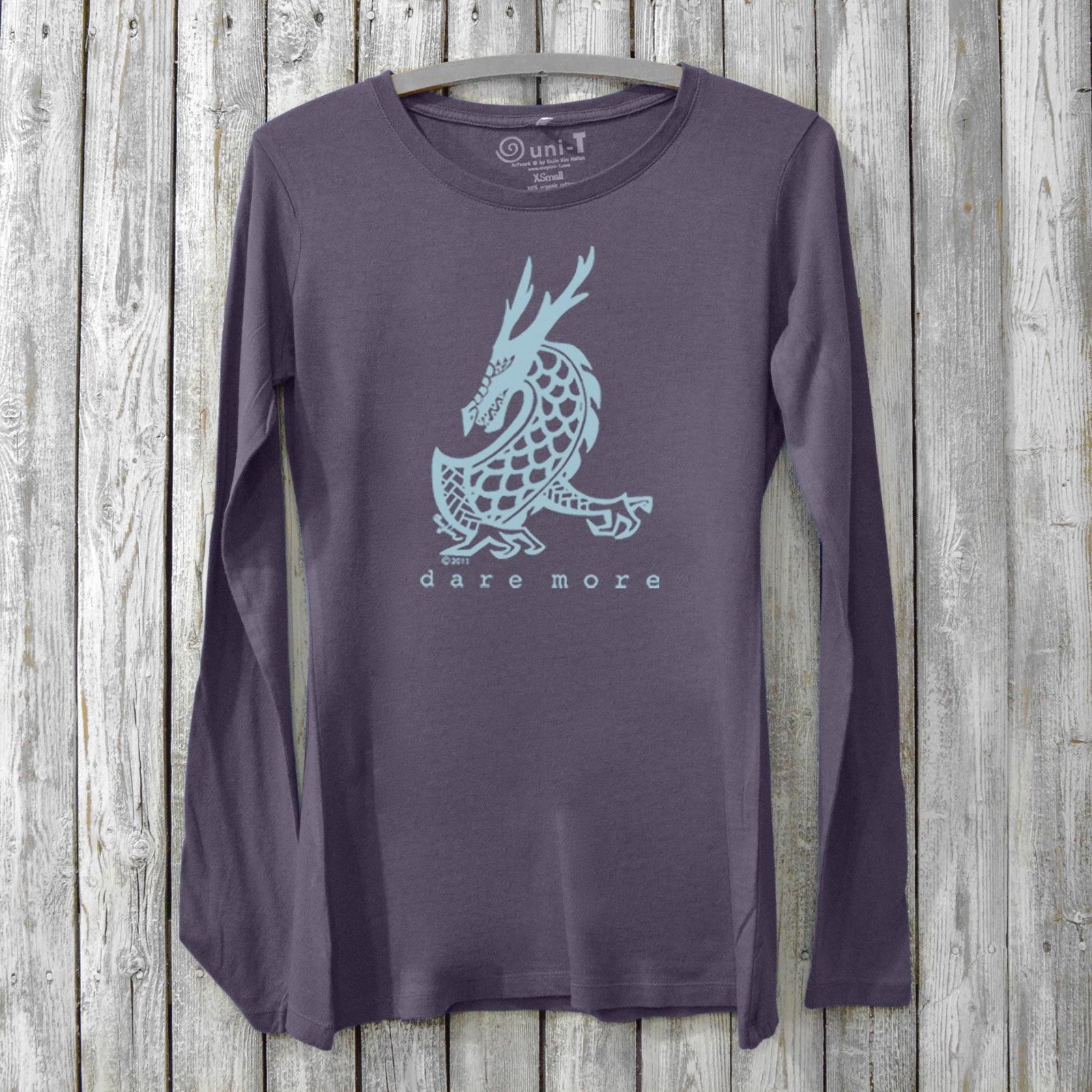 Dark purple women's long sleeve graphic tee in bamboo and organic cotton with light blue dragon and 'Dare More' print. Mythical design for bold living.