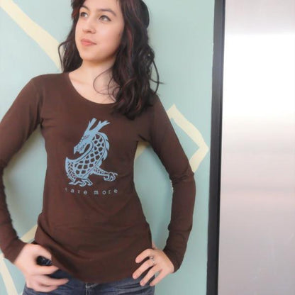 Model wearing brown 'Dare More' dragon long sleeve T-shirt made from bamboo and organic cotton. Stylish gift for adventurous women.