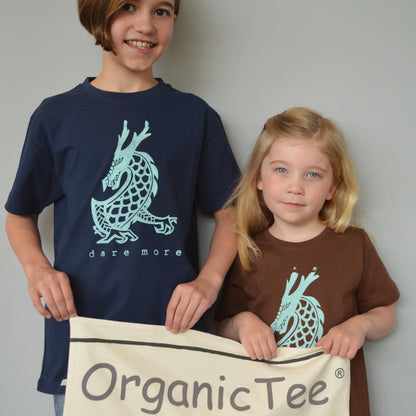 Kids wearing Uni-T 'Dare More' dragon graphic T-shirts in navy and brown, made from organic cotton. Eco-friendly fantasy apparel for children.