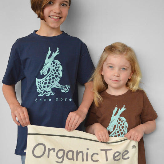 Kids wearing Uni-T 'Dare More' dragon graphic T-shirts in navy and brown, made from organic cotton. Eco-friendly fantasy apparel for children.