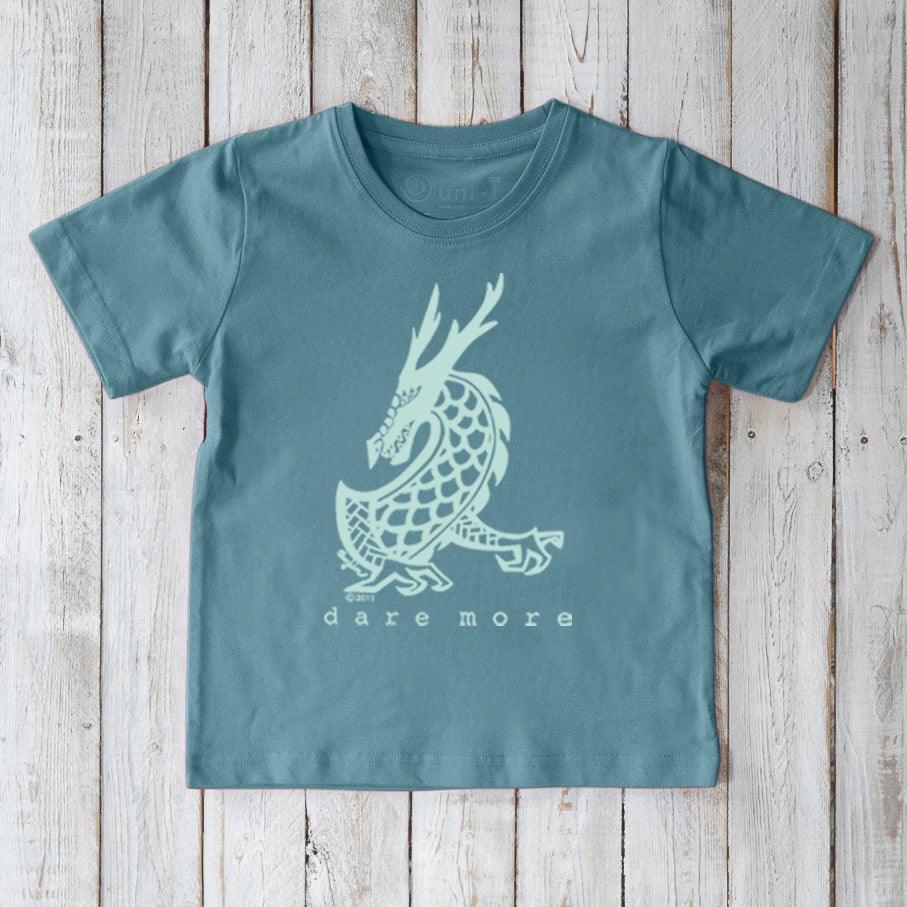 Blue Kids' Organic Cotton T-Shirt featuring a light dragon illustration and 'dare more' slogan. Eco-conscious fantasy graphic tee by Uni-T.