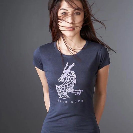 Woman wearing the 'Dare More' dragon T-shirt in navy blue, made from bamboo and organic cotton. Sustainable fantasy graphic tee for women by Uni-T.