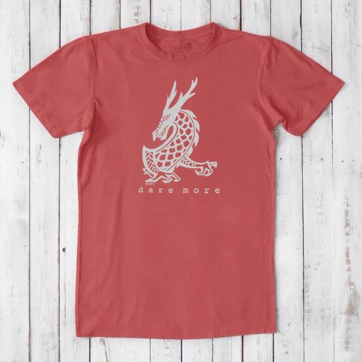 Coral red men's bamboo and organic cotton t-shirt with white dragon illustration and 'Dare More' text, fantasy adventure graphic tee.