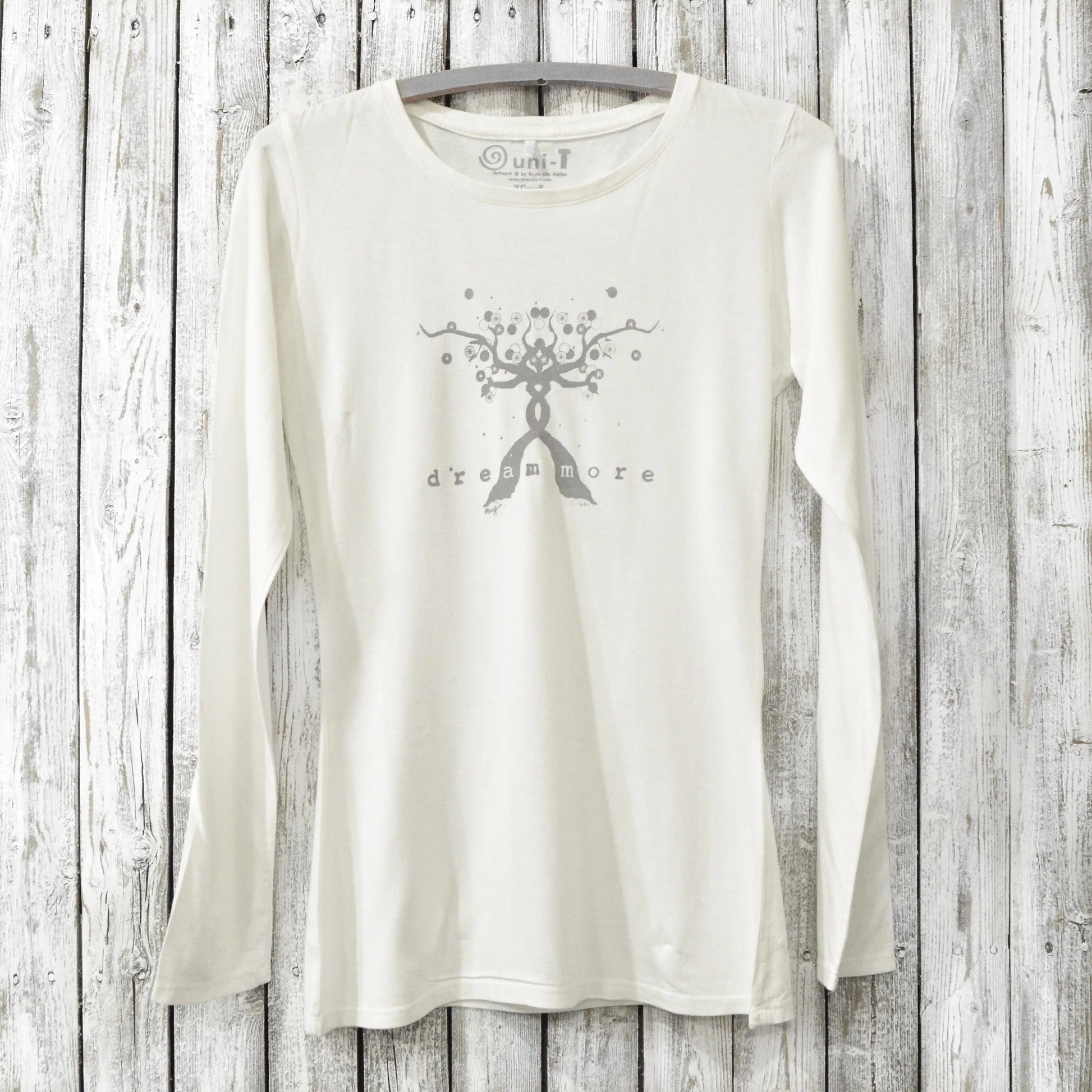 White long sleeve inspirational tee for women with 'Dream More' tree design, made from bamboo and organic cotton for cozy comfort.