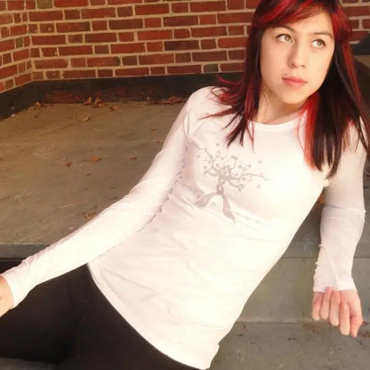 Model wearing white 'Dream More' bamboo and organic cotton long sleeve shirt, perfect gift for dreamers seeking comfort and style.