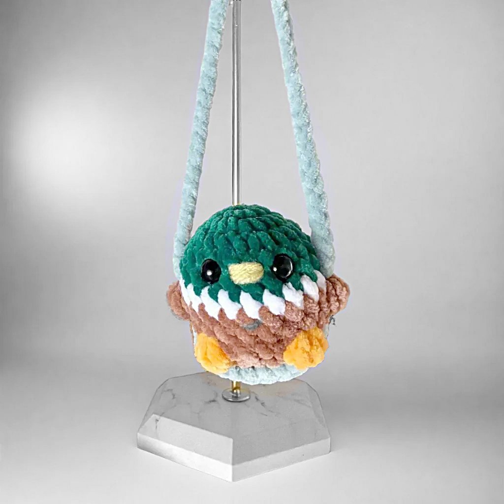 Duck Car Mirror Swing - Duck Car Mirror Accessory featuring a handmade plush duck in green, brown, and white chenille yarn on an 8-inch swing.