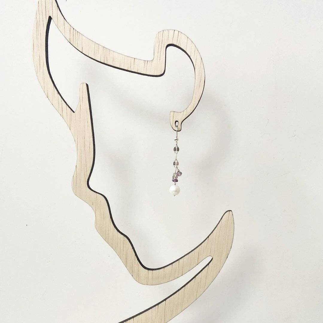Single Cultured Pearl Amethyst Earring hanging on a minimalist wooden display, highlighting its elegant drop style and gemstone detailing.