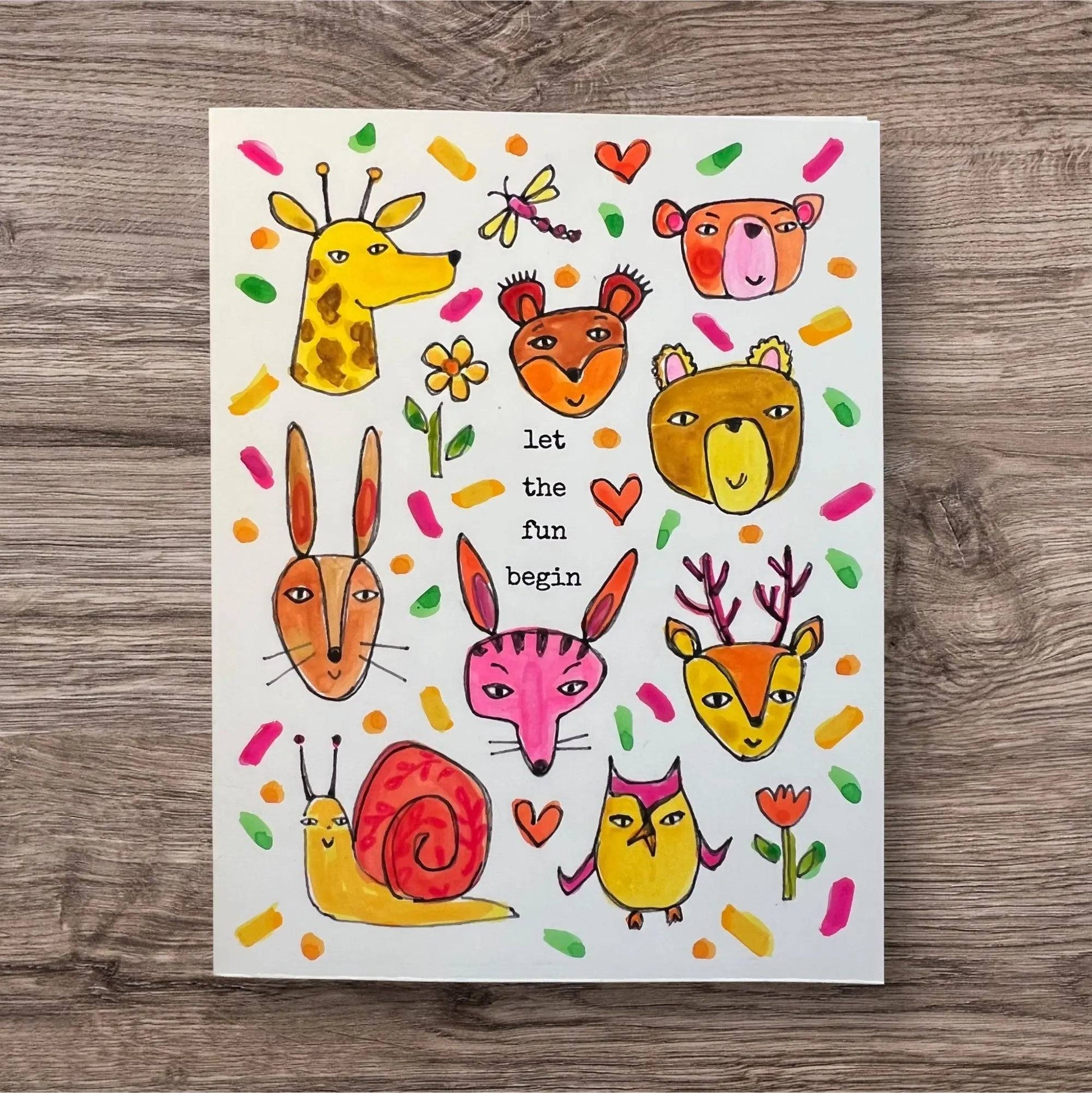 Hand-painted Good Vibe Tribe Greeting Card with playful animal faces and text 'let the fun begin' for cheerful, motivational gifting.