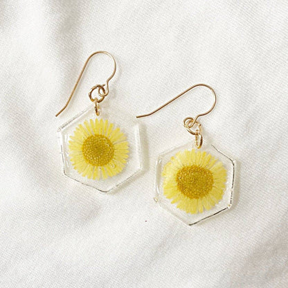 Hexagon resin earrings with pink and yellow flowers. Gold hooks highlight the colorful floral design from Real Flower Earrings.