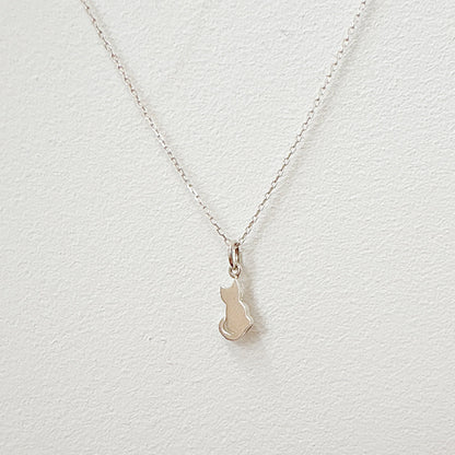 Silver kitty necklace on hand