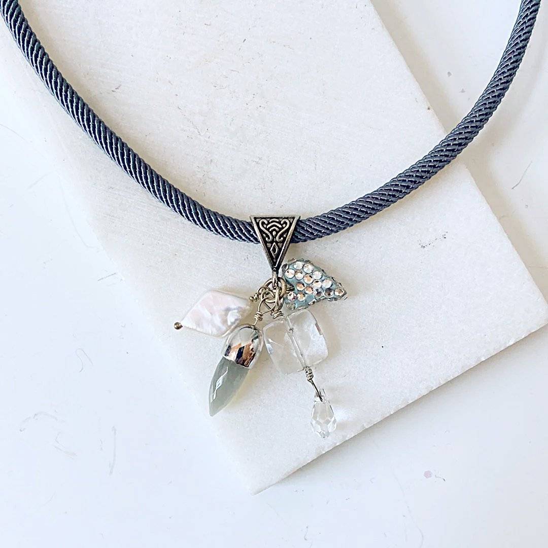 Heart and Pearl Charm Necklace-Uni-T with crystal pave heart, freshwater pearl, and quartz charms on a grey twisted cord. Elegant and stylish design.