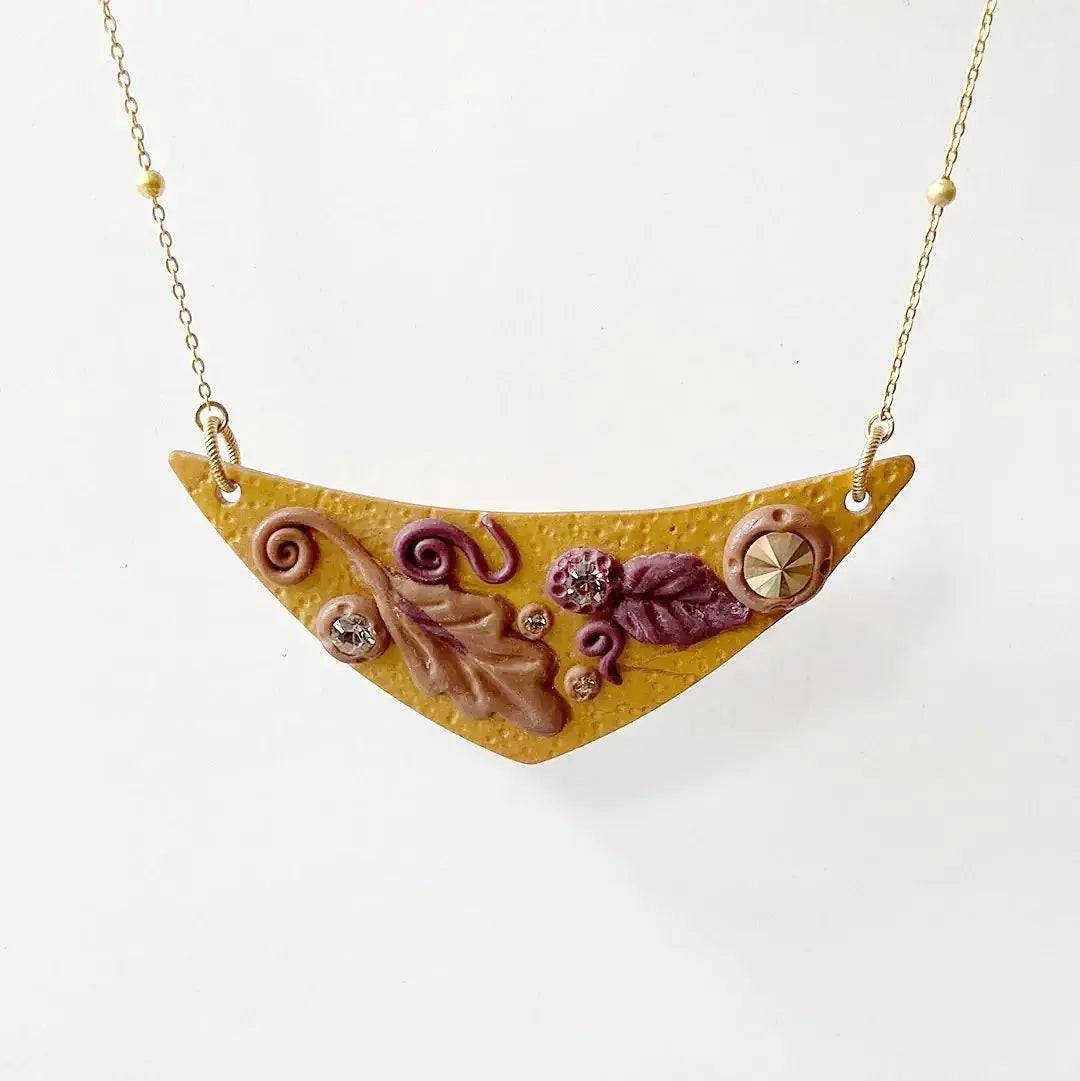 Autumn-themed Fall Leaves Bib Necklace with handcrafted polymer clay pendant, featuring intricate leaf details and gold chain. Stylish fall accessory.