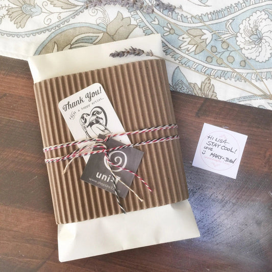 Eco-friendly packaging for Giraffe Organic Tote Bag, wrapped in kraft paper with twine and thank-you tag, showcasing sustainable gift presentation.