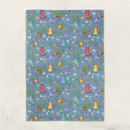 Garden Soul Tea Towel hanging on a wall with gardening pattern