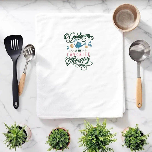 Gardening Is My Favorite Therapy Towel - Embroidered Gift displayed on a kitchen counter with utensils and potted plants, ideal for garden lovers.