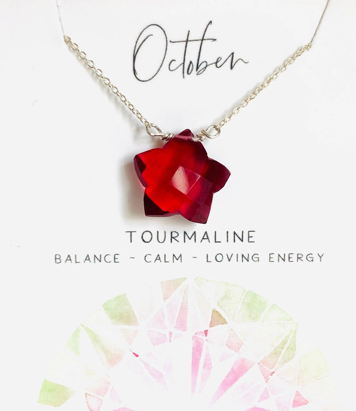 October birthstone necklace featuring red tourmaline star pendant on silver chain, promoting balance and loving energy.