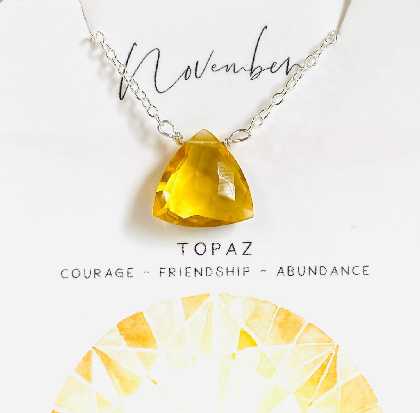November birthstone necklace with yellow topaz crystal pendant, symbolizing courage and abundance, on sterling silver chain.
