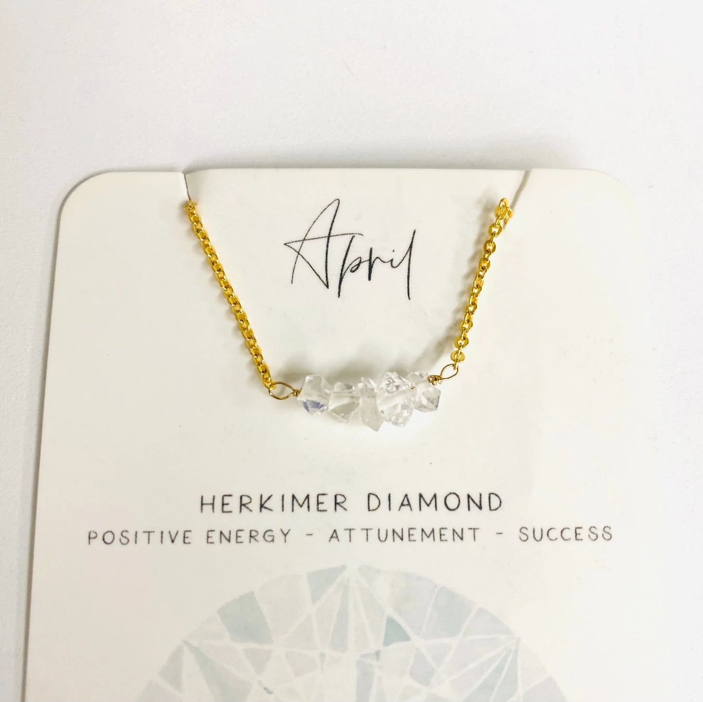 April birthstone necklace with Herkimer diamond chips on gold chain, representing positive energy and attunement.