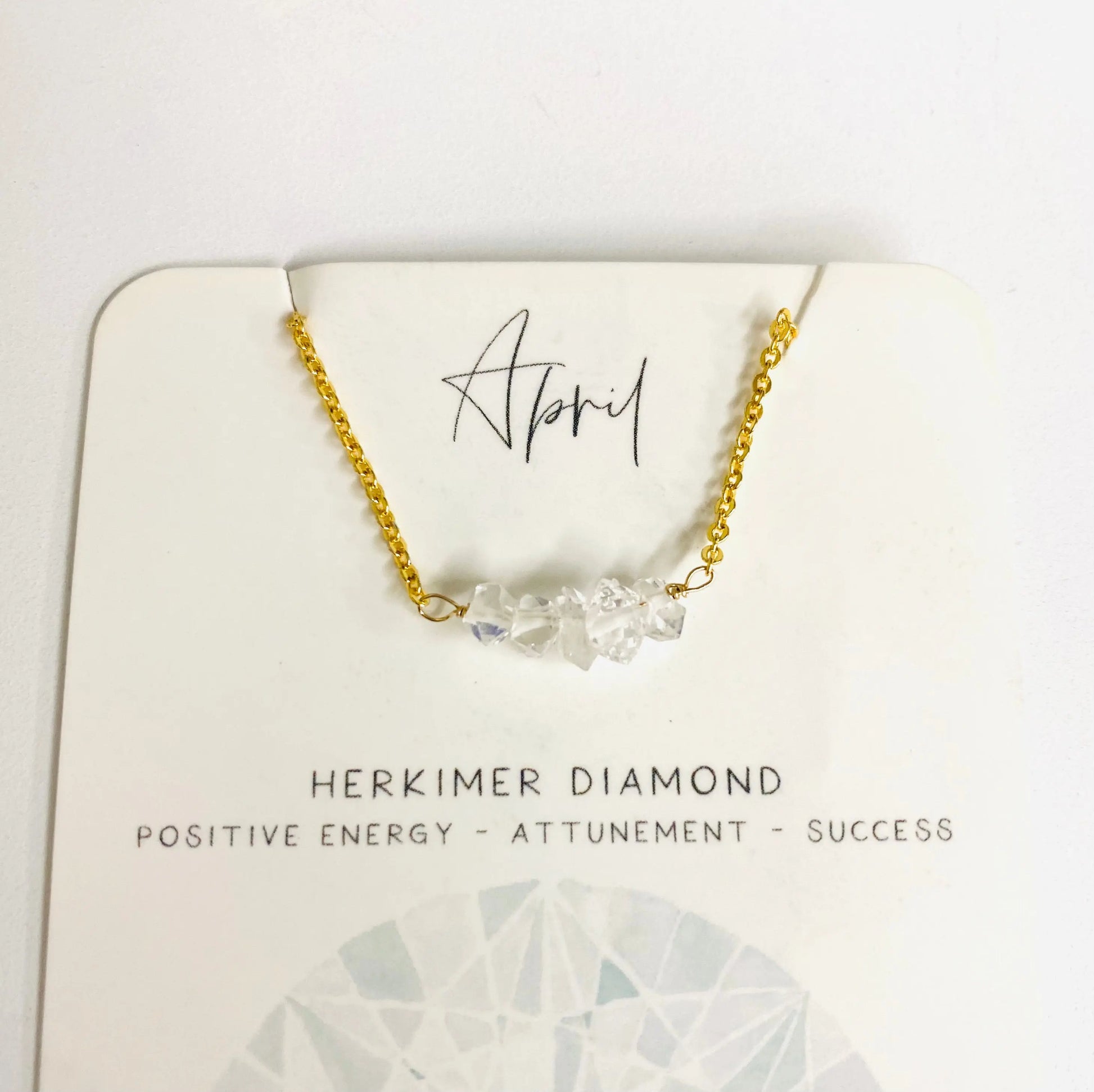 April birthstone necklace with Herkimer diamond chips on gold chain, representing positive energy and attunement.