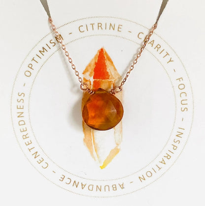 Citrine gemstone necklace with round faceted pendant on rose gold chain, symbolizing optimism and abundance.