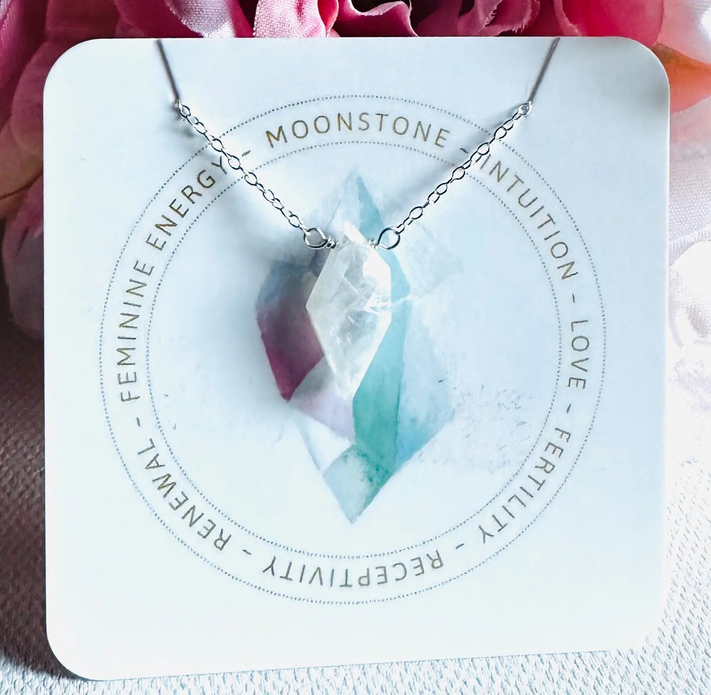 Moonstone crystal necklace on silver chain, symbolizing intuition and feminine energy, from handmade gemstone collection.