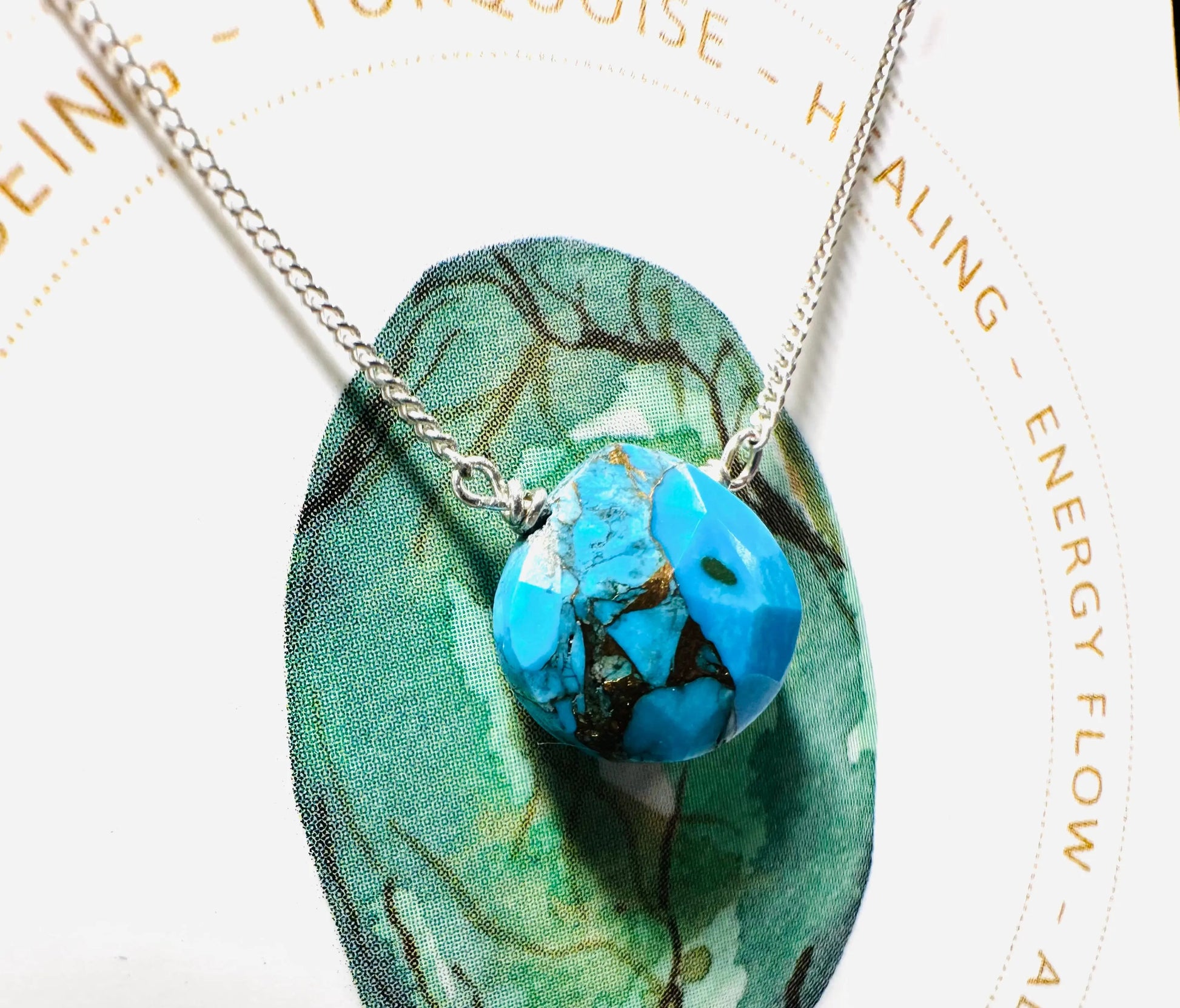 Turquoise teardrop pendant necklace on silver chain, symbolizing healing and energy flow, from handmade gemstone collection.