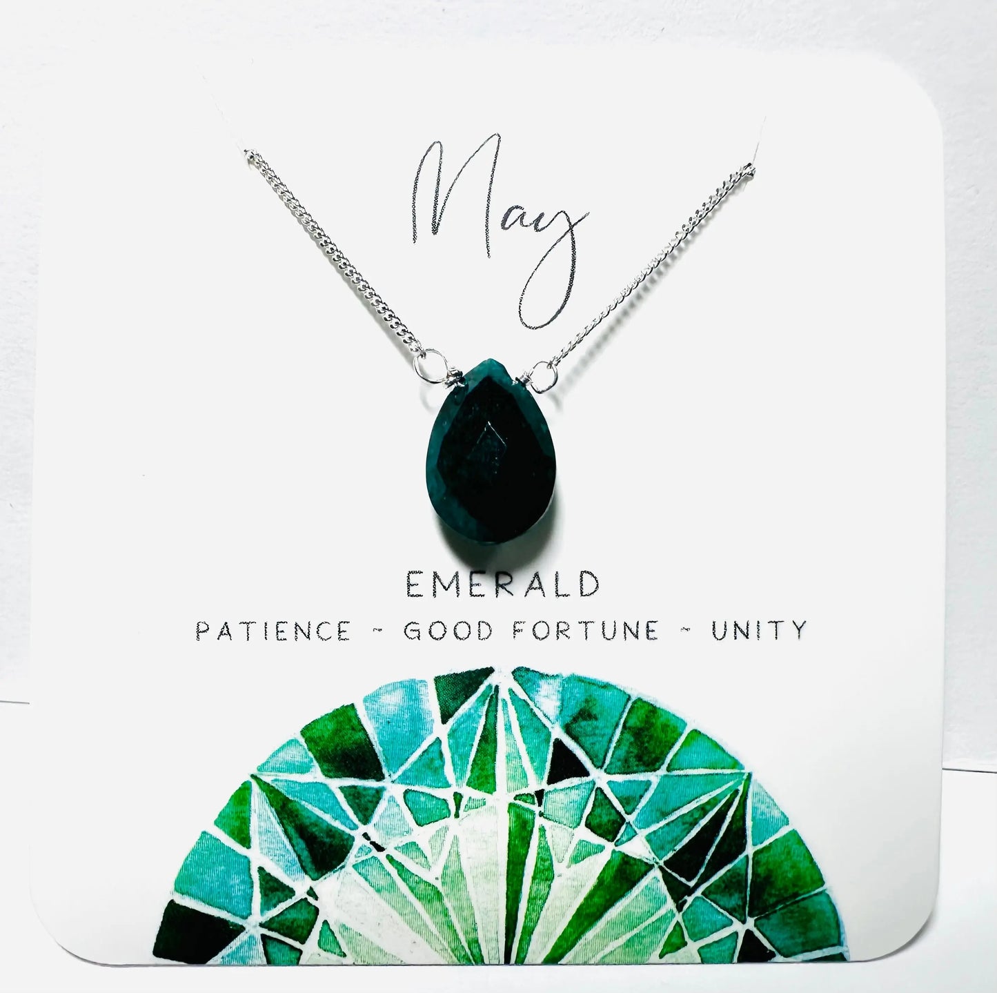May birthstone necklace featuring emerald teardrop pendant on silver chain, symbolizing patience and unity.