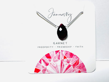 January birthstone necklace with garnet teardrop pendant on silver chain, symbolizing prosperity and friendship.
