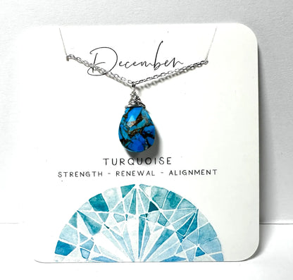December birthstone necklace with turquoise teardrop pendant on silver chain, symbolizing strength and renewal.