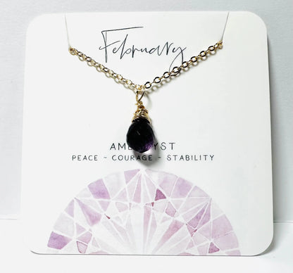 February birthstone necklace with amethyst teardrop pendant on gold chain, symbolizing peace and stability.