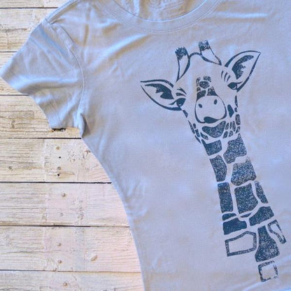 Light blue Women's Giraffe T-Shirt with navy safari animal print. Made from sustainable bamboo and organic cotton for stylish wildlife fashion.